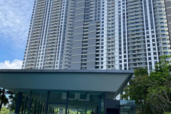 A high-rise building with multiple balconies and a modern architectural design.