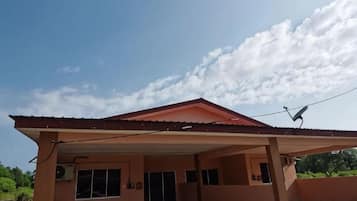 A single-story building with a flat roof and a covered patio area.
