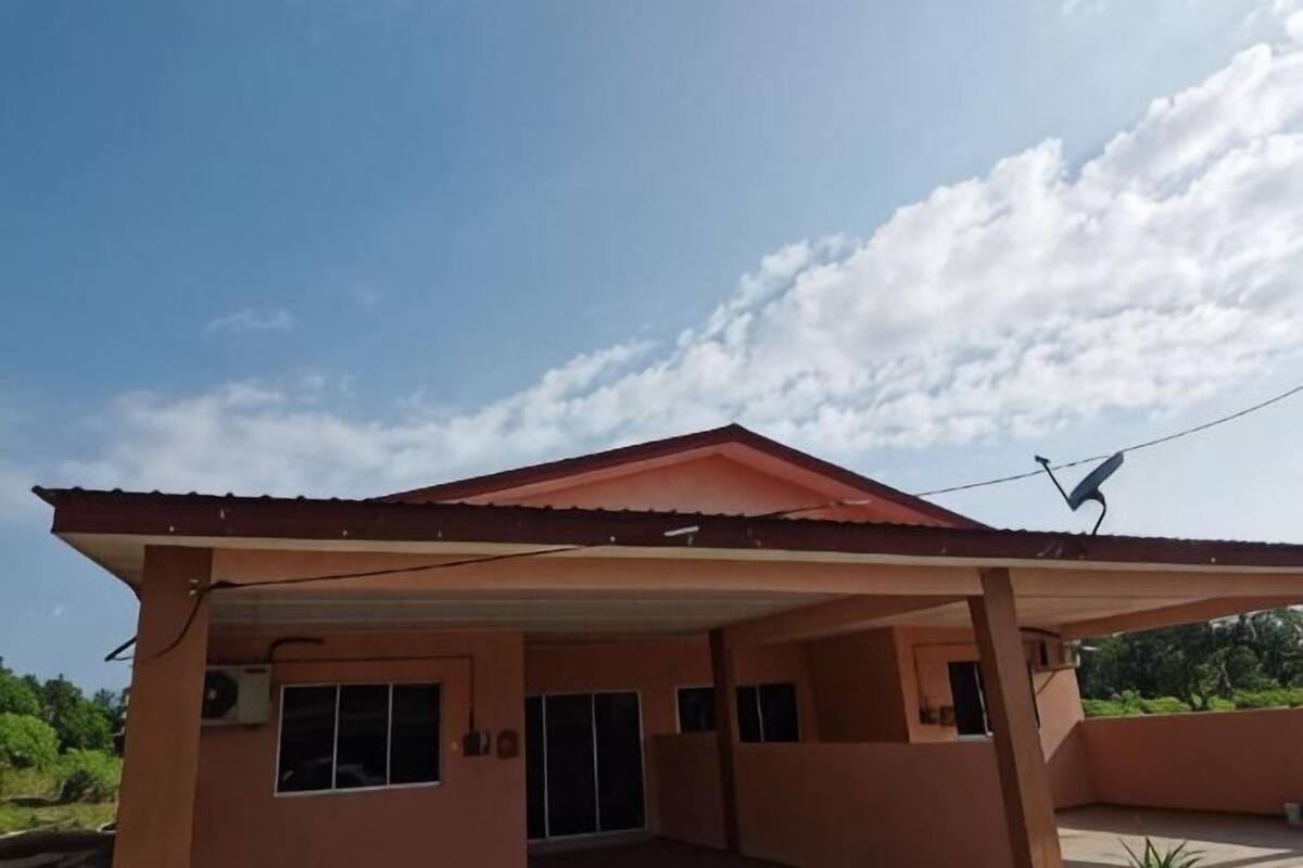 A building with a covered patio, a satellite dish, and a clear sky.