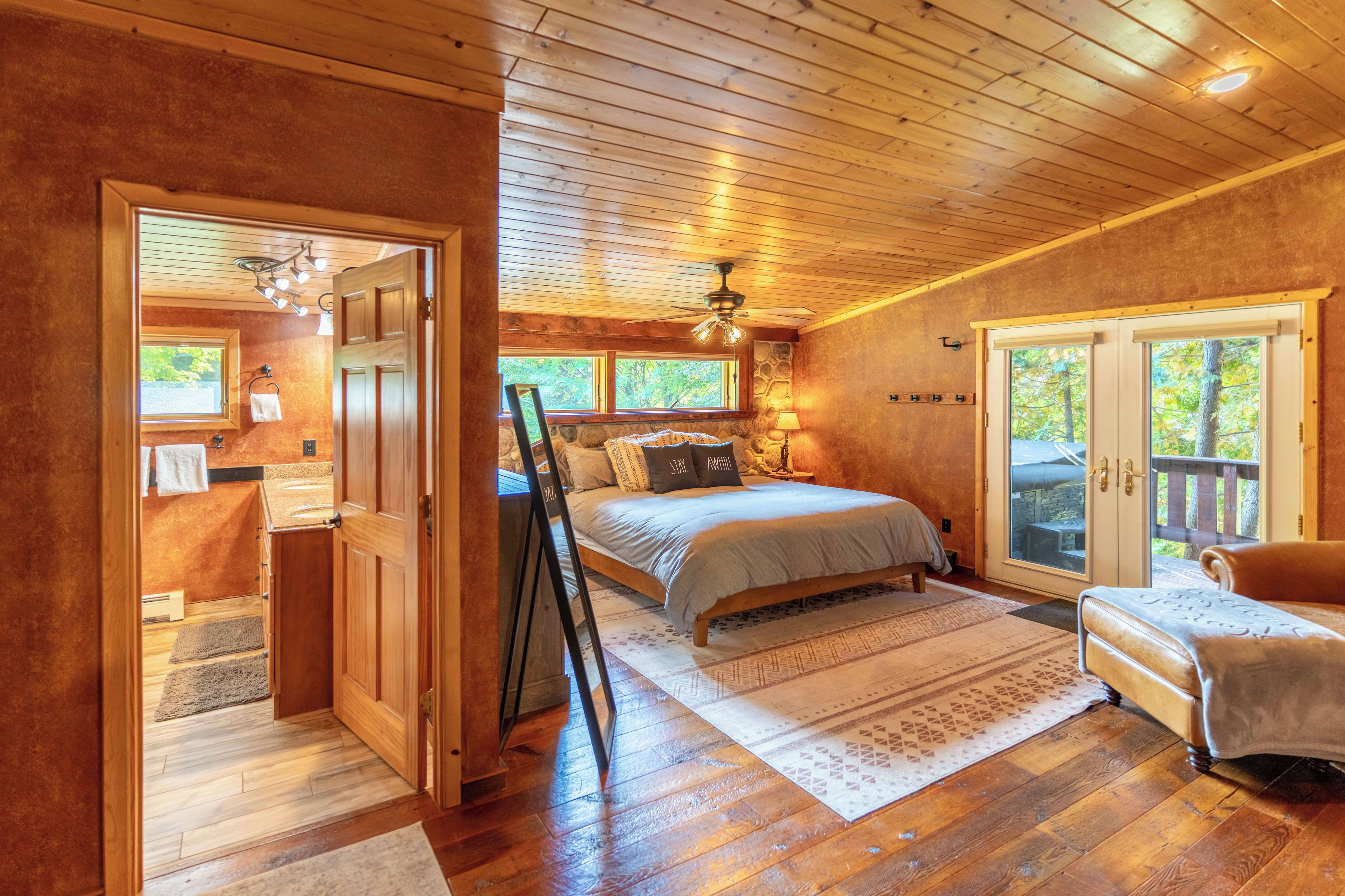 Master bedroom with attached full bathroom and walkout patio