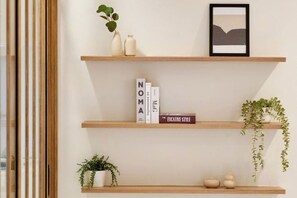 A minimalist shelf with books, a framed picture, and decorative items. - AIRI Home,3BR near Thapae and walking str old town CNX (Chiang Mai)