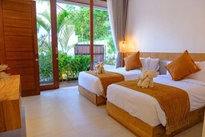 A hotel room with two beds, a wooden floor, a view of greenery, and a sliding door. - Villa Moon Orchid - 3 bedroom villa (Bali)