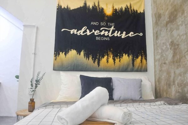 Une chambre à coucher avec un lit, une tapisserie murale et une plante sur la table de chevet.