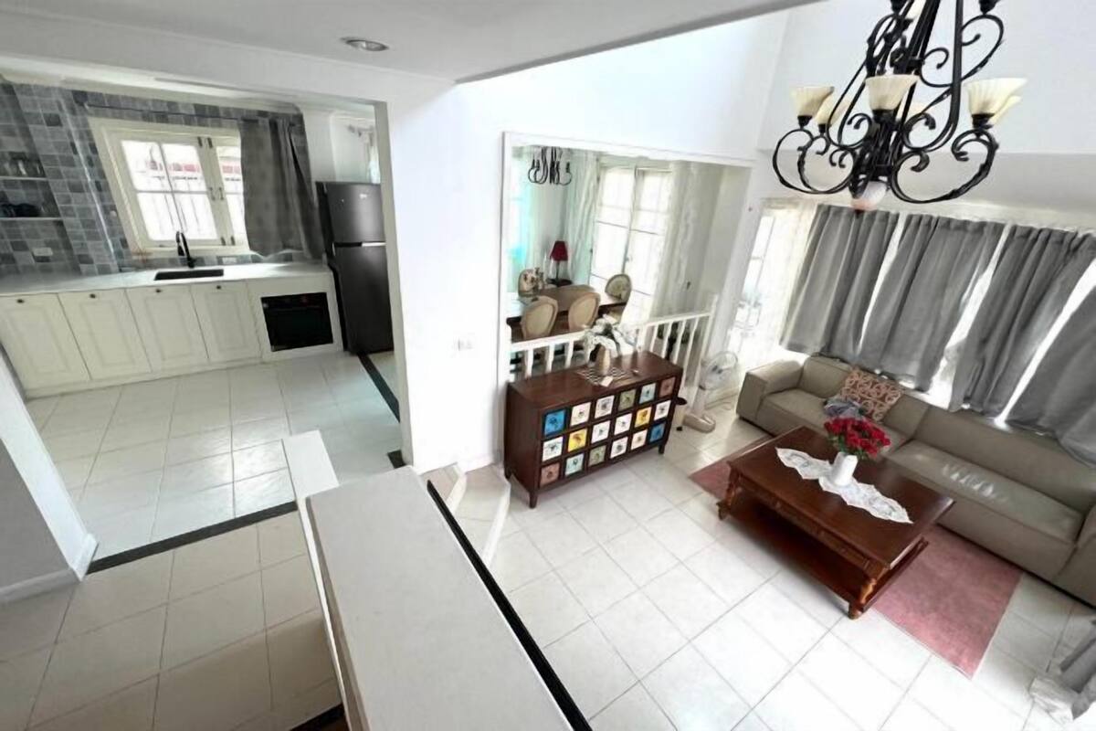 A modern apartment with a kitchen, dining area, and living room.