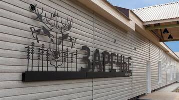 A building with a sign that reads '3APES' and a deer graphic.
