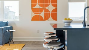 A modern kitchen with a black countertop, a sink, and a bowl of lemons on the counter. - Deluxe Four-Bedroom Suite + Balcony | The Carter (Nashville)