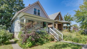 A two-story house with a front porch, a staircase leading to the second floor, and a well-maintained garden. - Classic Forest Park Foursquare < 1 Mi to Blue Line (Forest Park)