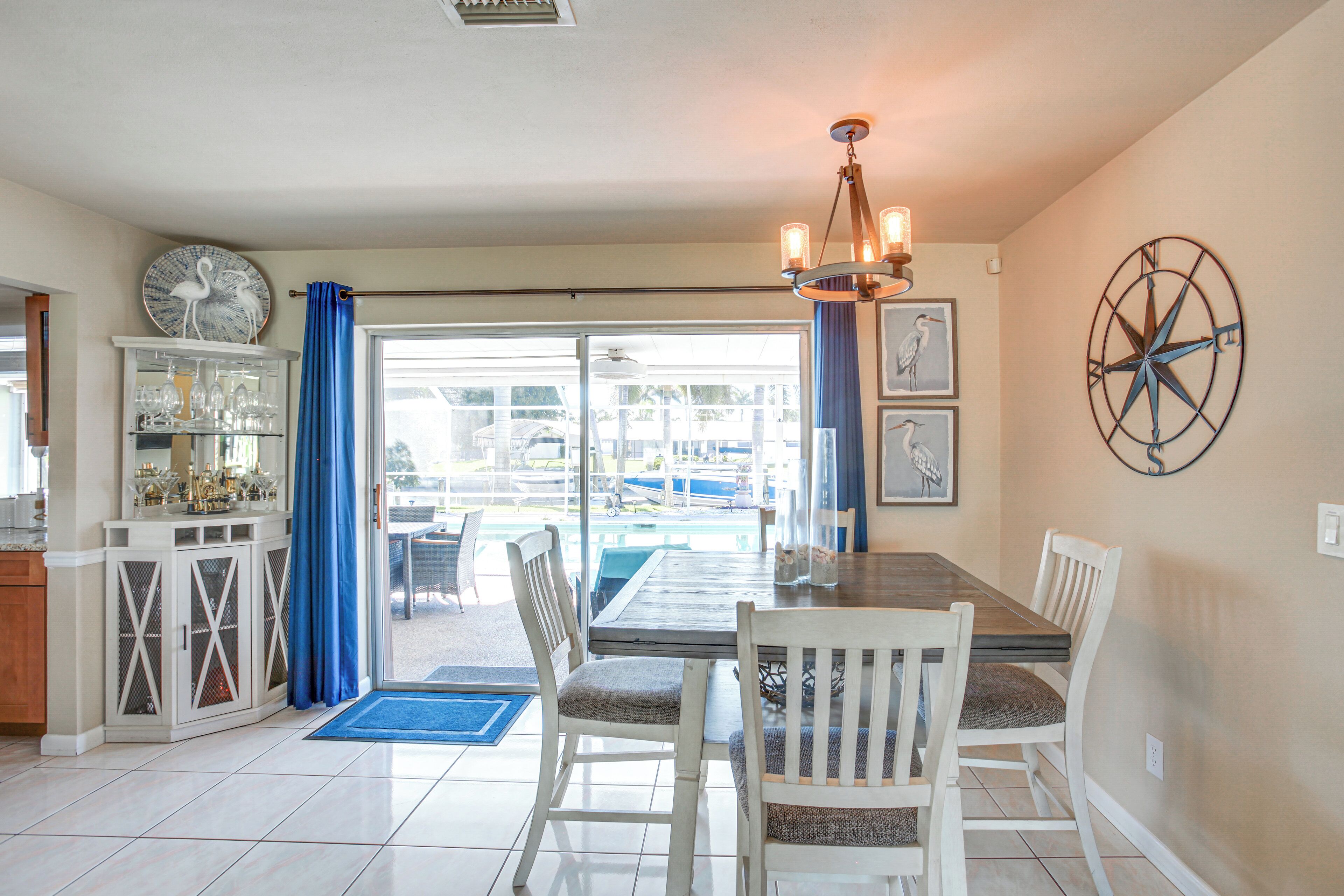 A dining area with a table, chairs, and a view of the outdoors.