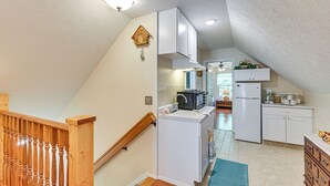 A kitchen with white cabinets, a microwave, and a refrigerator. - 4 Mi to Downtown Delphi: Trails & Fishing Pond (Delphi)