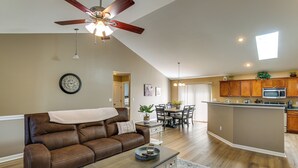 A spacious living room with a brown leather sofa, a wooden coffee table, and a ceiling fan. - Sip, Soar & Explore: Spacious Union Home w/ Yard (Union)
