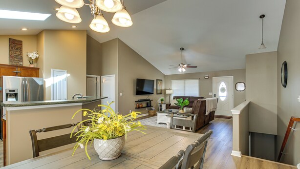 A spacious living area with a dining table, chairs, a sofa, and a television. - Sip, Soar & Explore: Spacious Union Home w/ Yard (Union)