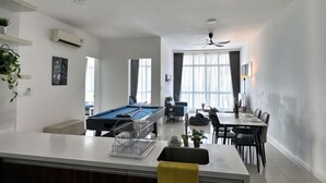 A modern living room with a pool table, dining area, and a kitchen counter. - Sky88 Residence Johor Bahru (Johor Bahru)