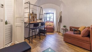 A compact living space with a kitchenette, a sofa, and a dining area. - Stay in a real medieval tower (lower floors) (Tallinn)