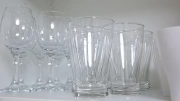 A collection of clear glassware on a shelf.