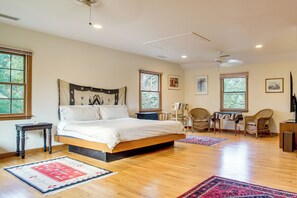 A bedroom with a large bed, wooden flooring, and two windows. - 4,200 Sq Ft Mid-cape Cottage w/ Furnished Deck! (Brewster)