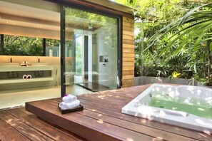 A spa area with a wooden deck, a hot tub, and a glass-enclosed shower. - The View (Koh Samui)