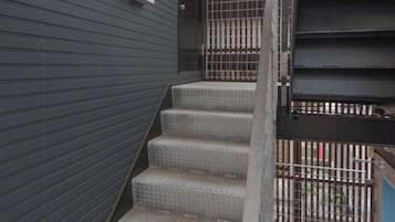 A set of metal stairs leading to a gated entrance.