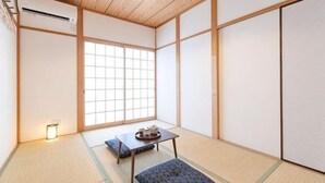 A traditional Japanese room with tatami flooring, a low table with a tray, and sliding doors. - KIRAKU･RAKUTEI (Kyoto)