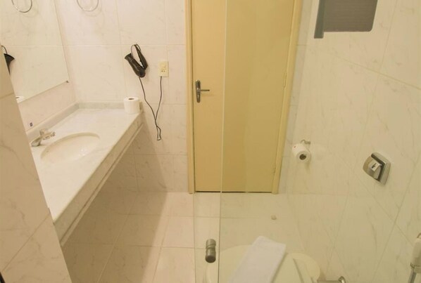A bathroom with a sink, toilet, and shower.