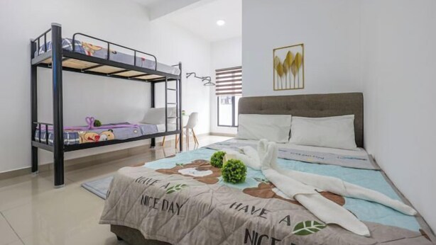 A bedroom with bunk beds, a bed with a floral bedspread, and a wall-mounted light fixture. - Airport#F1#KLIA#Mitsui#Transit#INTI#NILAI#SepangF1 (Sepang)