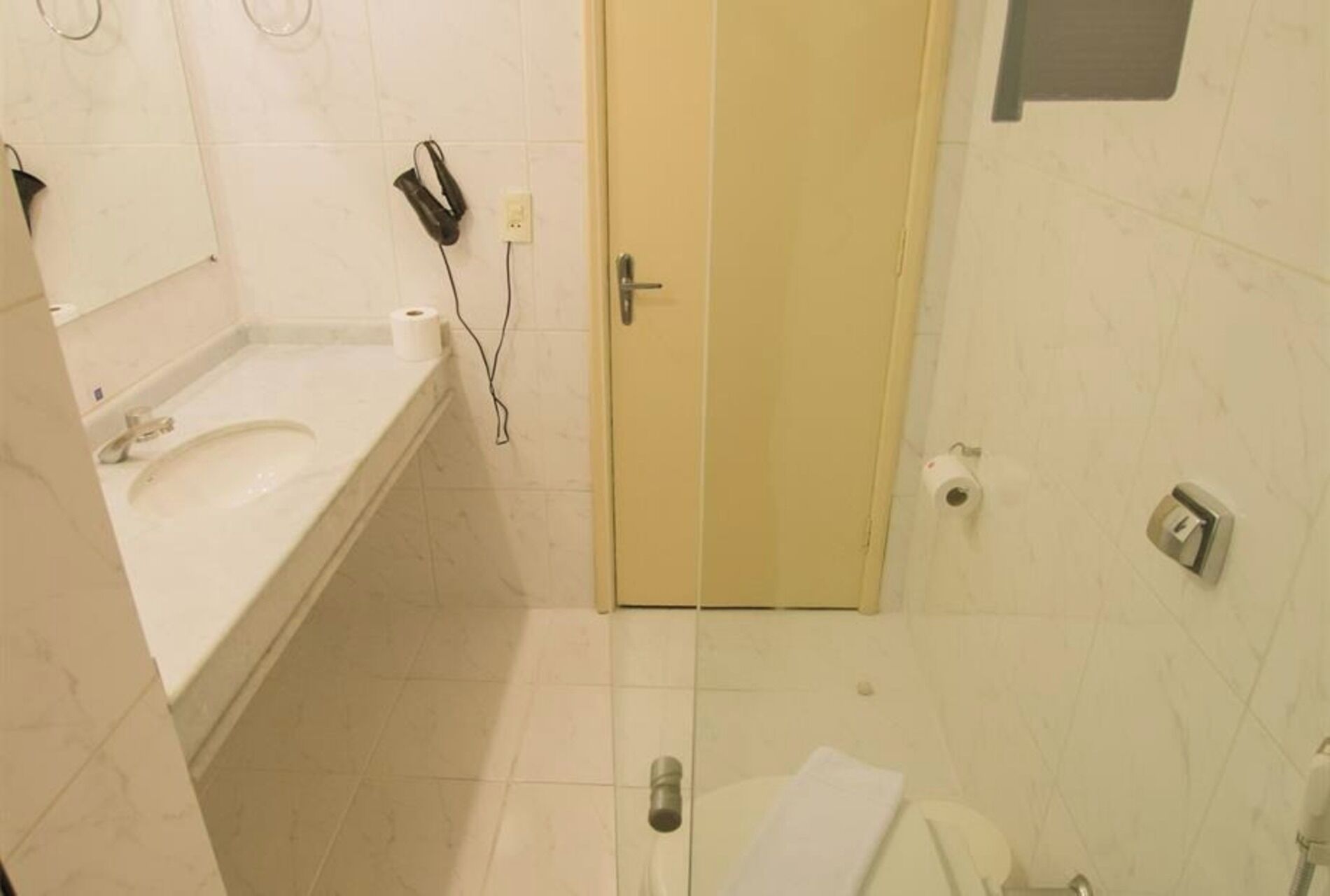 A bathroom with a sink, toilet, and shower.