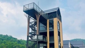 A modern building with a spiral staircase, multiple floors, and large windows. - Relax Pool Villa Khaoyai (Pak Chong)