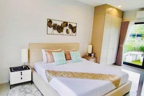 A modern bedroom with a large bed, bedside tables, a wall-mounted artwork, and a view of the outdoors through a window. - Relax Pool Villa Khaoyai (Pak Chong)
