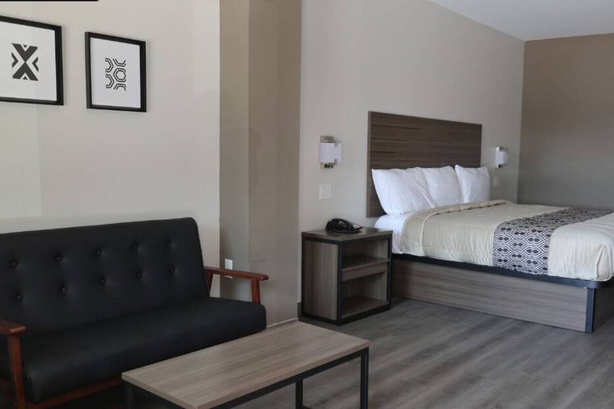 Desk, laptop workspace, blackout drapes, iron/ironing board