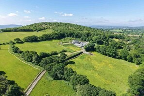 A rural property with a large field, a building, and surrounding greenery. - Hopkins Retreat Farm - 5 Bedroom House - Swansea (Mawr)