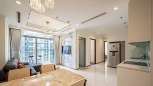 A modern living room with a marble dining table, a sofa, and a large window with curtains. - Landmark Center Saigon (Ho Chi Minh City)