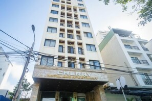 A hotel named 'Cherry Hotel and Apartment' with a modern facade, multiple floors, and a prominent entrance. - Cherry Apartment & Hotel (Da Nang)