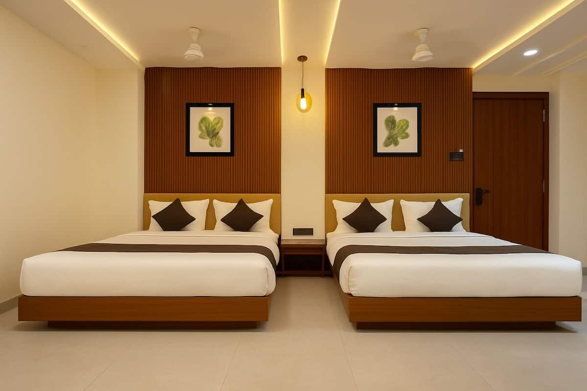 A hotel room with two beds, wooden headboards, and a ceiling light fixture.