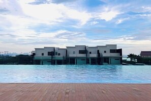 A modern building with a pool in front. - Paragon Residence Johor Bahru (Johor Bahru)