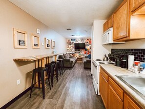 A kitchen with wooden cabinets, a microwave, and a coffee maker.