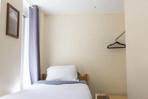 Escritorio, tabla de planchar con plancha, wifi y ropa de cama