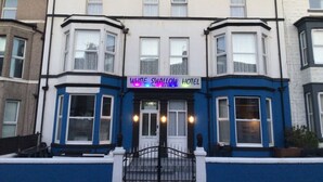 A hotel with a prominent sign, a gated entrance, and a traditional architectural style. - The White Swallow Hotel (Blackpool)