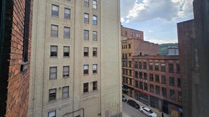 A multi-story building with a brick facade and multiple windows. - Cozy Downtown Pittsburgh Apartment | Smart TV + Wa (Pittsburgh)