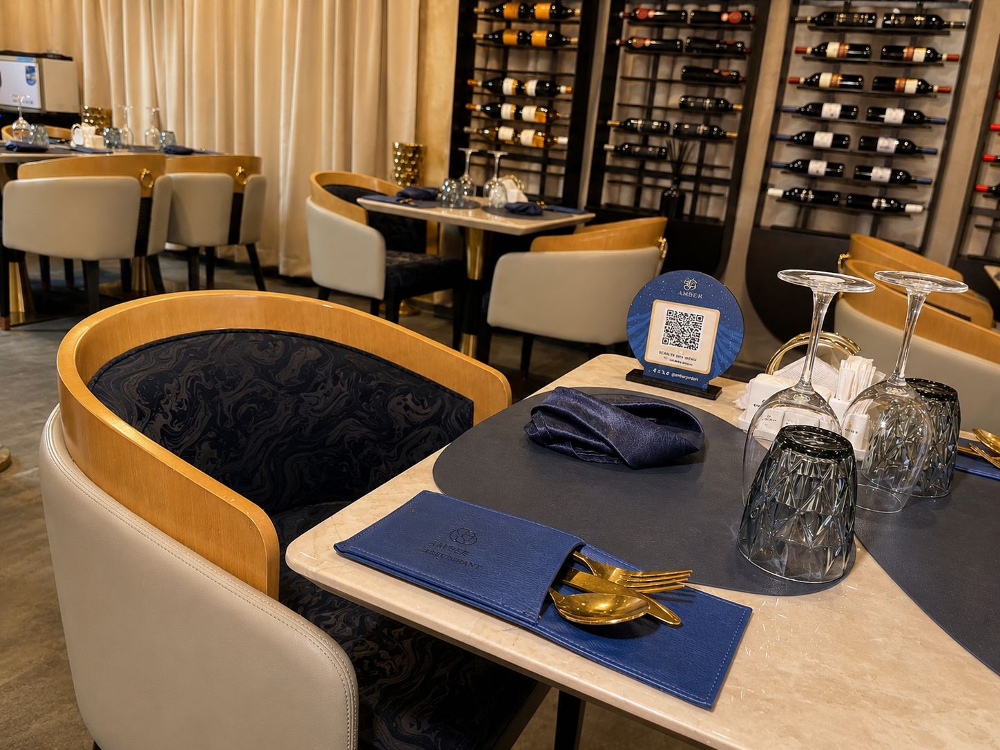 A restaurant interior with tables set for dining, wine racks in the background, and a QR code on the table.