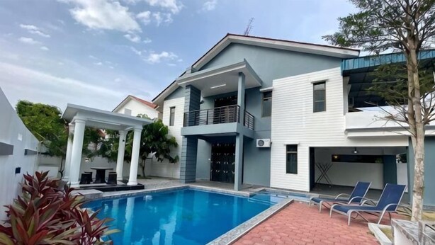 A modern two-story house with a swimming pool, a covered patio, and a balcony. - Stylish Blue Water Home w/ Pool (Tebrau)