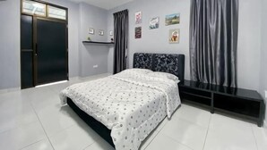 A bedroom with a bed, a black headboard, a window with curtains, a door, and a shelf with pictures. - Stylish Blue Water Home w/ Pool (Tebrau)