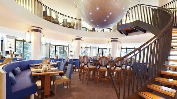 A spacious lobby with a central seating area, a staircase, and large windows. - Club Med Valmorel (Les Avanchers-Valmorel)