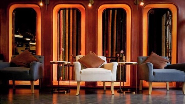 A modern lounge area with a white armchair, two blue armchairs, and a small round table. - DAY & NIGHT by THE MOMENT (Chiang Mai)