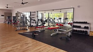 A gym with various exercise equipment, a mirror wall, and a motivational quote. - KLIA Sepang Alanis Comfort One Bed Room Unit (Sepang)