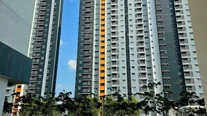 A high-rise residential building with multiple balconies and a central vertical orange stripe. - KLIA Sepang Alanis Comfort One Bed Room Unit (Sepang)