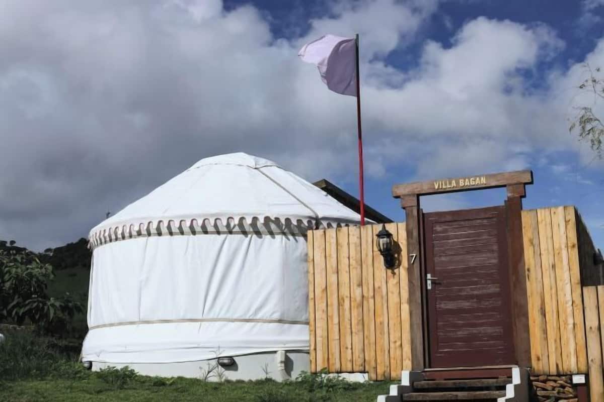A yurt with a wooden fence and a door labeled "Villa Bagan".