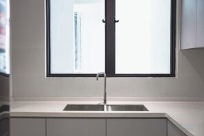 A kitchen with a window above a sink. - The Marina View Johor Bahru (Plentong)