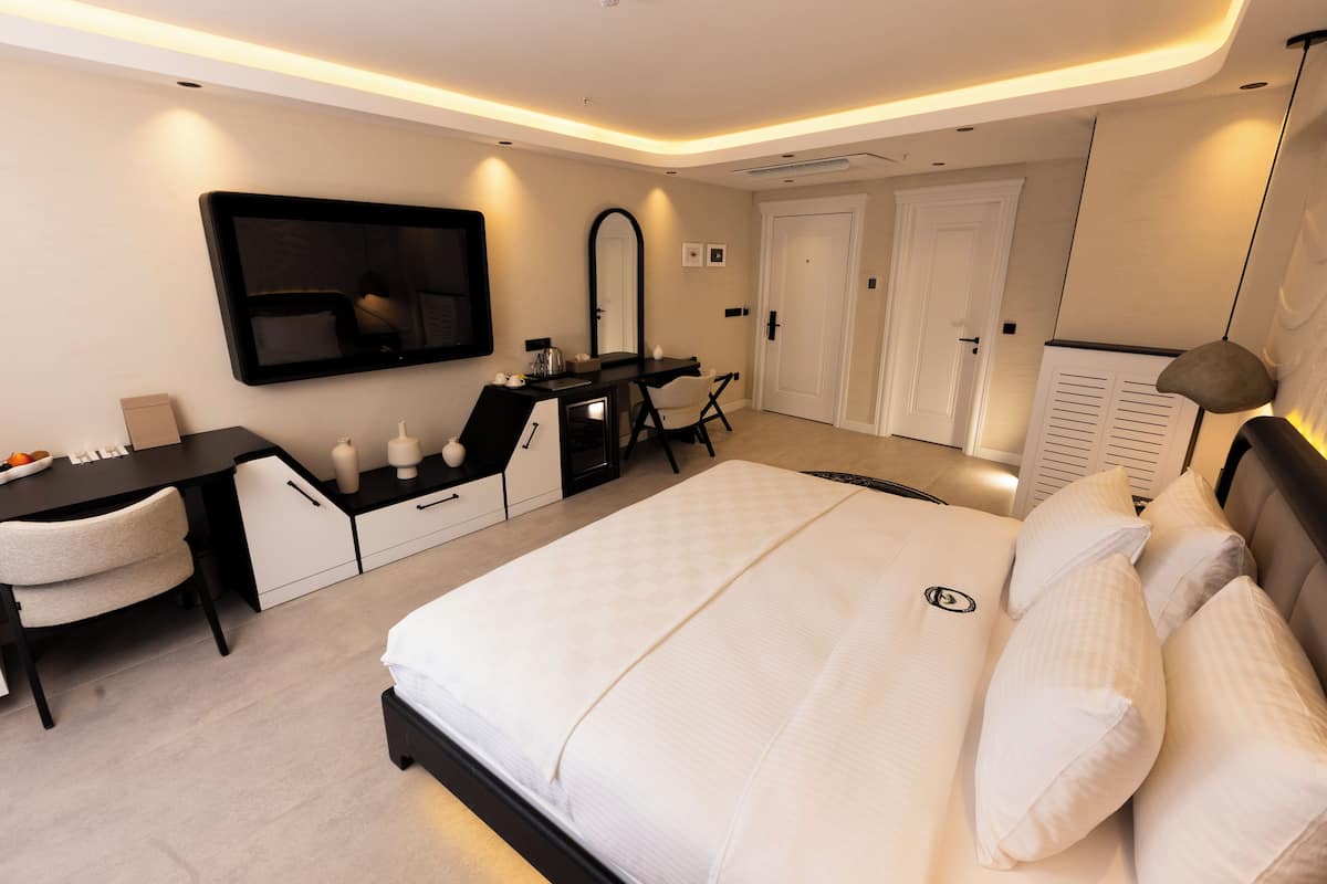 Deluxe Room, Balcony, City View | In-room safe, desk, laptop workspace, iron/ironing board