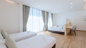A modern hotel room with two single beds, a desk, and a chair. - Minimalist 4BR Private Cozy Pool Villa - VVP26.11 (Pattaya)