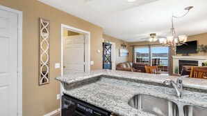 A kitchen with granite countertops, a dishwasher, and a double sink. - Lake Harbour on TRL For 6 (Hollister)