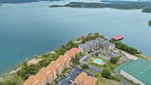 A resort with multiple buildings, a swimming pool, and a view of a large lake. - Lake Harbour on TRL For 6 (Hollister)